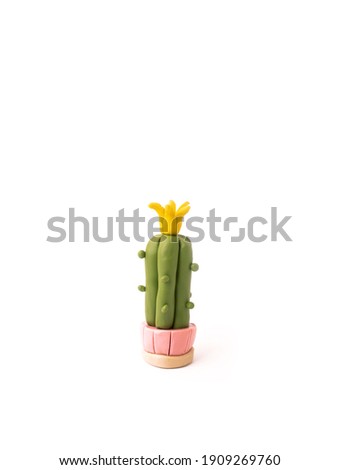 plasticine cactus with a flower in a pink pot on a white background