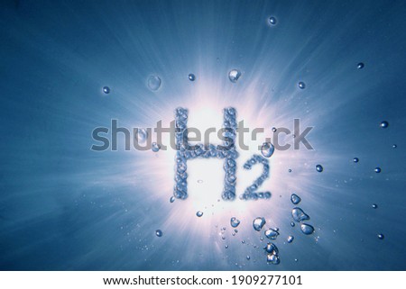 letters hydrogen h2 with lot of bubbles in a blue water with sun and rays