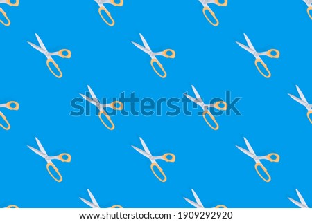 Scissors seamless pattern. Barber scissors on a blue background. 