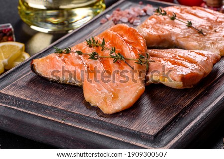 Tasty fresh red fish arctic char baked on a grill. Source of omega, healthy food Royalty-Free Stock Photo #1909300507