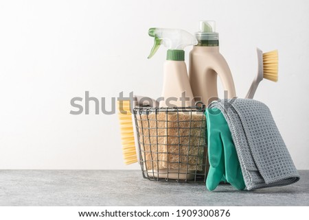 Brushes, sponges, rubber gloves and natural cleaning products in the basket.  Eco-friendly cleaning products Royalty-Free Stock Photo #1909300876