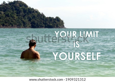 A word YOUR LIMIT IS YOURSELF on the blurry landscape background. concept for motivational and inspiration.