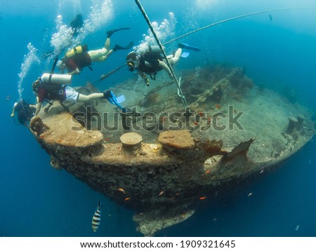 Scuba divers in the bow of a shipwreck (Thistlegorm, Red Sea, Sharm El Sheikh, Egypt) Royalty-Free Stock Photo #1909321645