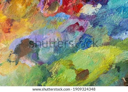 Abstract multi-colored background with oil paint. Hand-textured background for the design. A mixture of turquoise, green, blue and purple colors on the canvas. Summer art background. Artist's palette