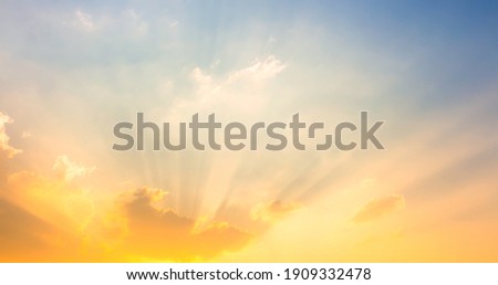 orange and yellow sunset light on sky with sun rays Royalty-Free Stock Photo #1909332478
