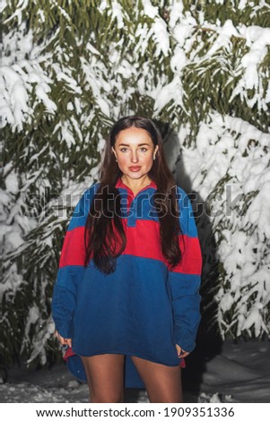 beautiful brunette among snowy fir trees, people in winter