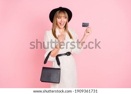 Full length photo of lady hand chest hold credit card wear retro cap dotted dress boots isolated pink color background