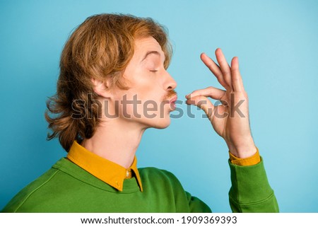 Profile side photo of young handsome funky funny man tasting enjoying delicisous food isolated on blue color background Royalty-Free Stock Photo #1909369393