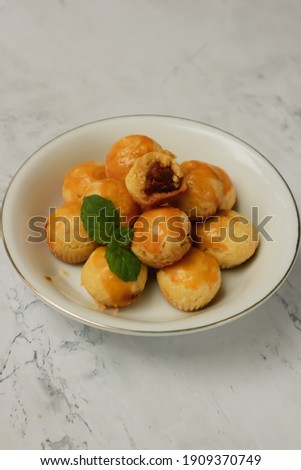 Unfocus picture of many pieces of nastar. Indonesian pineapple tart cookies served to celebrate Eid al Fitr or Idul Fitri. Isolated.