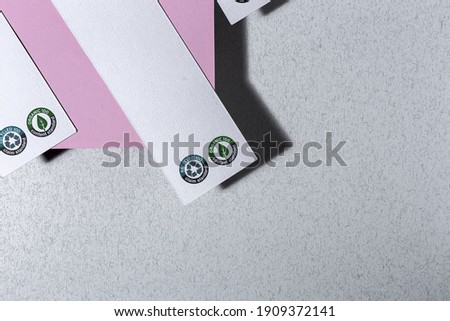 Recyclable and organic cardboard labels with logo on a colorful background with high contrast