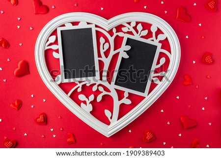 White love frame and small red hearts on pink background. St. Valentine day concept.