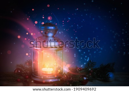Composition with Christmas lantern on wooden table. Magical atmosphere 