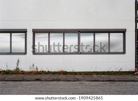 outside front of a laboratory with privacy shield foil on the windows. room for text.