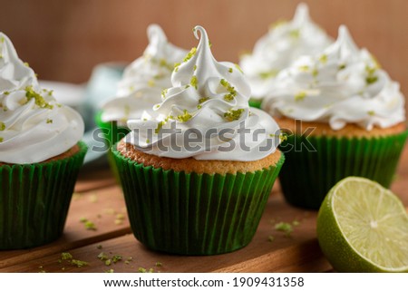 Tasty cupcakes with lemon on a wooden table. Image with selective focus.
