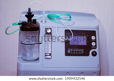the oxygen concentrator or oxygen generator is designed for oxygen therapy in medical institutions and individual use at home. Allows you to get high-concentration oxygen by filtering the surrounding  Royalty-Free Stock Photo #1909432546