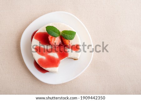 Top view cheesecake garnished with fresh strawberries and berry syrup Royalty-Free Stock Photo #1909442350