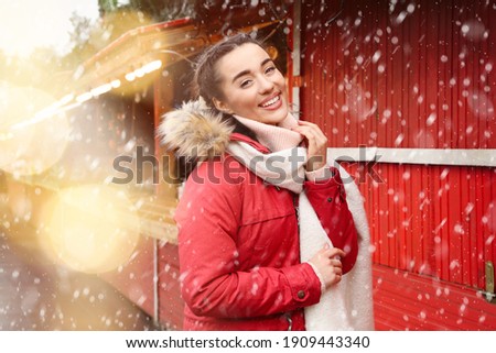 Happy young woman at winter fair. Christmas celebration