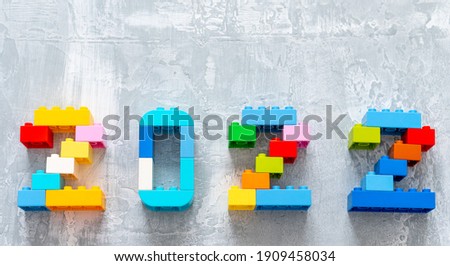 multicolored numbers 2022 from kids constructor set on isolated gray background with place for text Royalty-Free Stock Photo #1909458034