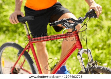 fitness, sport and healthy lifestyle concept - young man with bicycle outdoors