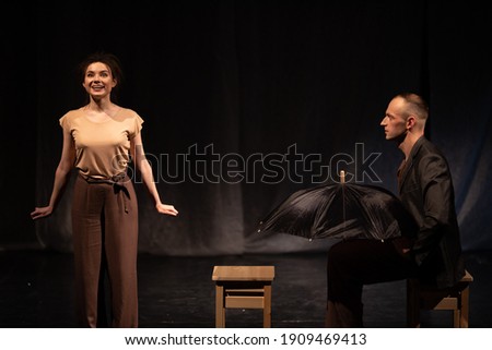 Actors and actresses play a modern lyrical performance of the theater stage show Royalty-Free Stock Photo #1909469413