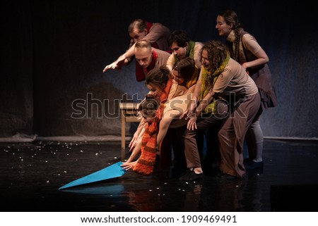 The actors on the stage play an emotion performance on a black background in stage light	 Royalty-Free Stock Photo #1909469491