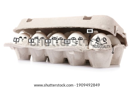 Funny chicken eggs in box on white background. Concept of uniqueness