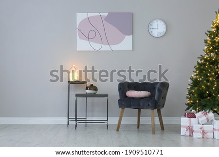 Light room interior with Christmas tree and armchair