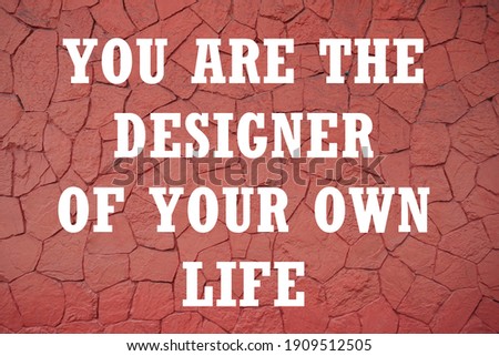 You are the designer of your own life motivational quote. Red brick wall texture.