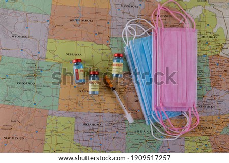 Travelling after immunization in the vaccine bottle, syringe with travel during covid-19 pandemic protection medical mask on North America map background