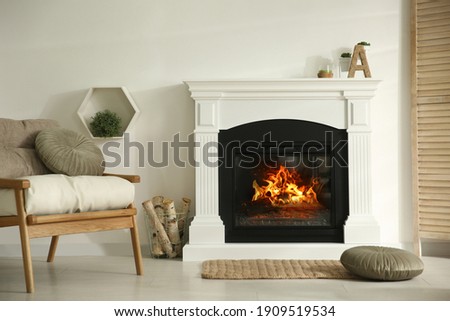 Bright living room interior with fireplace and basket of firewood