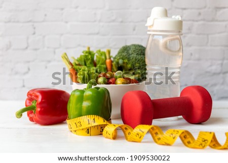 Diet Healthy food and lifestyle health concept. Sport exercise equipment workout and gym background with nutrition detox salad for fitness style. Healthy Concept Royalty-Free Stock Photo #1909530022