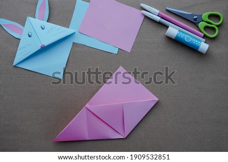 Step 5. Step by step photo instruction. DIY concept. How to make Origami paper bookmark form of bunny. Children's art project. . Easter greetings. creative ideas for kids.  a craft for children. 