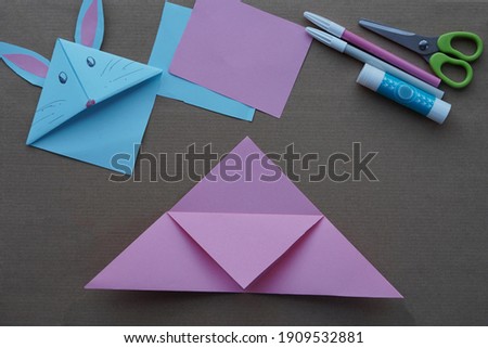 Step 4 Step by step photo instruction. DIY concept. How to make Origami paper bookmark form of bunny. Children's art project. . Easter greetings. creative ideas for kids.  a craft for children. 