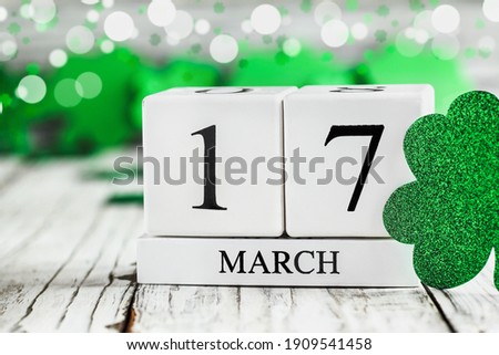 Happy St Patrick's day. White wood calendar blocks with the date March 17th. Selective focus with blurred background.
