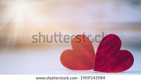 Close up of two red hearts on wooden table. Love, valentine's day concept.