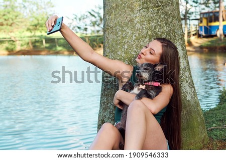 lifestyle photography with white model and pets in the field, during a warm summer afternoon in the mountains.