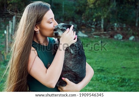 lifestyle photography with white model and pets in the field, during a warm summer afternoon in the mountains.