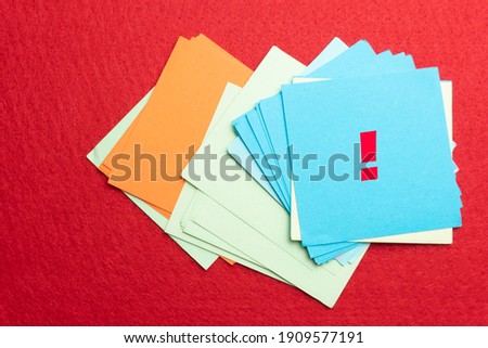 note paper with exclamation mark over red background