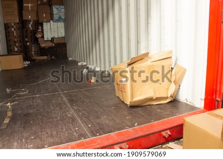 unloading carton from container and carton damage from loading or transport process.  Royalty-Free Stock Photo #1909579069