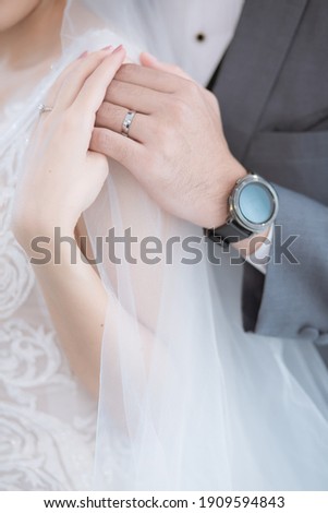 A picture of a married person holding a ring