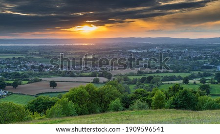 
An English village in a valley at sunset