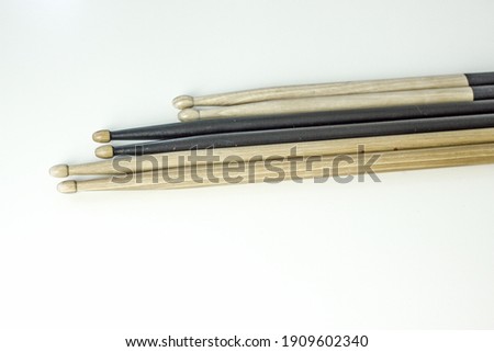 Drumsticks of black and light color on a light table