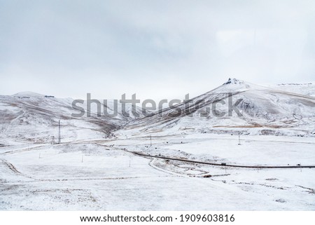 Amazing Natural Landscape view from above. Aerial shot of winter highlands. Mountainous snowy valley, Breathtaking view of winter texture. 
