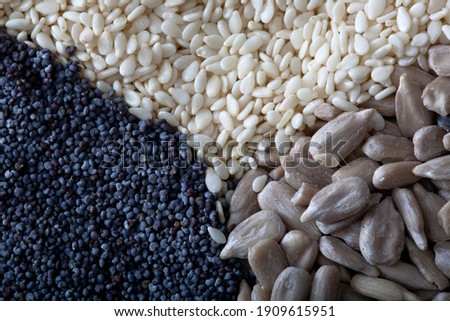 Healthy mix of seeds: poppy seeds, sunflower seeds and sesame. Close up picture.