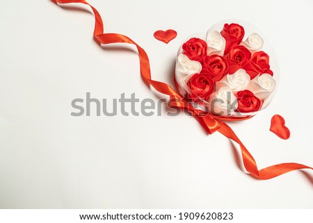 roses in a box of red ribbon hearts white background. concept Valentine's Day and Birthday . high quality