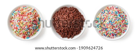 Set of colorful and chocolate candy sprinkles in white bowl isolated on white background, top view Royalty-Free Stock Photo #1909624726