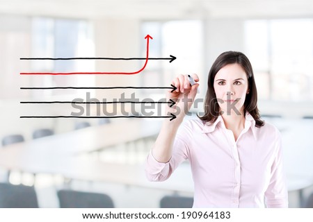 Businesswoman drawing arrows in different directions. Office background.