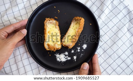 Homemade Crispy cheese  served with hand hold
