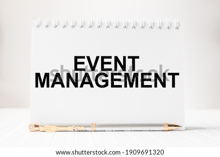 Notepad with inscriptions EVENT MANAGEMENT on a white background. business concept.
