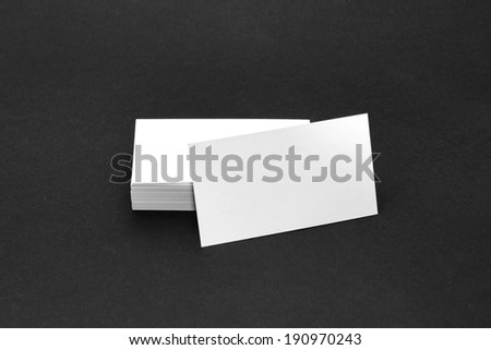 Business card template mockup for branding identity with blank modern devices. Isolated on black paper background.